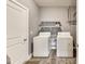 A functional laundry room complete with a washer, dryer, and ample shelving at 1396 Lexington Trl, Greenfield, IN 46140
