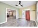 Open living room with gray floors leading into the kitchen area and access to the patio at 1396 Lexington Trl, Greenfield, IN 46140