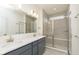 Bright bathroom with double sinks and a glass-enclosed shower with a built-in bench at 14521 Hanford Ln, Carmel, IN 46074