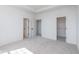 Bedroom with light-colored carpet, white walls, and open doorways to a second bedroom and the closet at 14521 Hanford Ln, Carmel, IN 46074