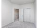 Carpeted bedroom featuring a sliding door closet, an open doorway, and white walls at 14521 Hanford Ln, Carmel, IN 46074