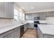 Beautiful kitchen featuring gray cabinets, stainless steel appliances, quartz countertops, and subway tile backsplash at 14521 Hanford Ln, Carmel, IN 46074