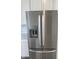 Stainless steel refrigerator with water and ice dispenser and sleek design, next to the white cabinets at 14521 Hanford Ln, Carmel, IN 46074