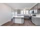 Bright kitchen showcases gray cabinets, white countertops, stainless steel appliances, and an island with seating at 14521 Hanford Ln, Carmel, IN 46074