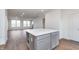 Spacious open-concept kitchen featuring a kitchen island and hardwood floors, with views of the living area at 14521 Hanford Ln, Carmel, IN 46074