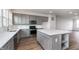 Modern kitchen with stainless steel appliances, gray cabinets, white subway tile backsplash, and kitchen island at 14521 Hanford Ln, Carmel, IN 46074