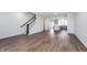 Open-concept living area showcasing hardwood floors, staircase, and flows into a modern kitchen, perfect for entertaining at 14521 Hanford Ln, Carmel, IN 46074