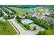 Aerial view showcasing a community pool surrounded by lounge chairs and lush landscaping, offering a resort-like experience at 15192 Montfort Dr, Noblesville, IN 46062