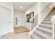Inviting foyer with hardwood flooring, a staircase, and natural light streaming through the front door at 15192 Montfort Dr, Noblesville, IN 46062