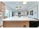 Bright, open kitchen featuring a white countertop island, pendant lights, and seamless connection to the living spaces at 15192 Montfort Dr, Noblesville, IN 46062
