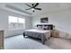 Serene main bedroom with tray ceiling, neutral carpet, large window, and tastefully decorated with soft furnishings at 15192 Montfort Dr, Noblesville, IN 46062