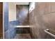 Bathroom walk-in shower featuring gray tile, bench, and showerhead at 15192 Montfort Dr, Noblesville, IN 46062