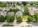 An aerial view shows the neighborhood and a two-story home with mature trees and green lawns at 1531 N College Ave, Indianapolis, IN 46202