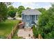 Aerial view of the backyard and patio featuring a hot tub, privacy fence, and stone steps at 1531 N College Ave, Indianapolis, IN 46202
