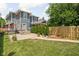 Backyard with a patio, privacy trees and manicured lawn at 1531 N College Ave, Indianapolis, IN 46202
