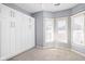 Bedroom with white built-in cabinets and large windows, providing ample storage and natural light at 1531 N College Ave, Indianapolis, IN 46202