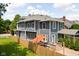 Aerial view of the back of the home with a hot tub and stone steps leading to a brick patio at 1531 N College Ave, Indianapolis, IN 46202