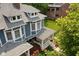 This aerial view highlights the home's covered porch, mature trees, and updated roof at 1531 N College Ave, Indianapolis, IN 46202