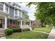 Charming two-story home with lush landscaping and a welcoming front porch at 1531 N College Ave, Indianapolis, IN 46202