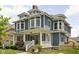 Charming two-story home with a well-manicured front yard and welcoming front porch at 1531 N College Ave, Indianapolis, IN 46202
