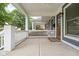 Covered front porch with classic white railings and a concrete floor at 1531 N College Ave, Indianapolis, IN 46202
