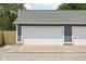 A two-car detached garage with a white door and blue siding at 1531 N College Ave, Indianapolis, IN 46202