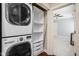 Stacked washer and dryer with adjacent shelving and closet space at 1531 N College Ave, Indianapolis, IN 46202