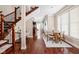 Bright and spacious dining room with hardwood floors and a view of the staircase and kitchen at 1531 N College Ave, Indianapolis, IN 46202