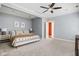 Spacious main bedroom with plush carpet, ceiling fan, and ample natural light at 1531 N College Ave, Indianapolis, IN 46202