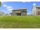 Expansive backyard view showing the home's ample yard and covered patio at 15546 Senita Ln, Fishers, IN 46037