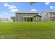Expansive backyard featuring a well-manicured lawn and a view of the home's rear facade at 15546 Senita Ln, Fishers, IN 46037