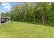 A view of the huge backyard featuring a lush green lawn and wooded backdrop at 15546 Senita Ln, Fishers, IN 46037