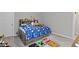 Cozy bedroom showcasing a sports-themed bed, a Minecraft rug, and a wooden headboard with storage at 15546 Senita Ln, Fishers, IN 46037