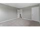 Empty bedroom with neutral walls, carpeted floors, and two doors at 15546 Senita Ln, Fishers, IN 46037