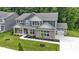 Beautiful two-story home boasts a brick facade, attached garage, and a well-manicured lawn with mature trees at 15546 Senita Ln, Fishers, IN 46037