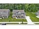 An exterior shot of the home's front yard with a long driveway and green grass at 15546 Senita Ln, Fishers, IN 46037