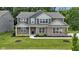 Beautiful two-story home with a brick facade, well-maintained lawn, and professionally landscaped front yard at 15546 Senita Ln, Fishers, IN 46037
