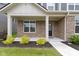 Inviting front porch with brick columns, lush landscaping, and a stylish front door for curb appeal at 15546 Senita Ln, Fishers, IN 46037