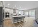 Open kitchen and living area with bar seating at island featuring quartz countertop and white cabinets at 15546 Senita Ln, Fishers, IN 46037