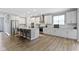 Modern kitchen featuring white cabinets, granite countertops, stainless steel appliances, and a center island with seating at 15546 Senita Ln, Fishers, IN 46037