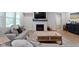 Comfortable living room with fireplace, stylish coffee table, and hardwood floors, perfect for relaxing at 15546 Senita Ln, Fishers, IN 46037