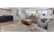 Open-concept living room leading to the kitchen with sleek wooden floors, a cozy rug, and modern décor at 15546 Senita Ln, Fishers, IN 46037