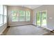 Sun-filled living room with large windows, vaulted ceilings, and sliding glass doors leading to backyard at 15546 Senita Ln, Fishers, IN 46037