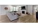 Bright living room featuring a fireplace, large windows, wood flooring, and neutral color palette at 15546 Senita Ln, Fishers, IN 46037