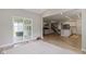 Open living area featuring hardwood floors, sliding door access to covered patio and access to kitchen at 15546 Senita Ln, Fishers, IN 46037