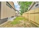 Backyard features a new wood fence and grass with window wells at 1555 N Dearborn St, Indianapolis, IN 46201