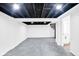 Spacious basement area with exposed ceiling, finished floors, and spiral staircase at 1555 N Dearborn St, Indianapolis, IN 46201
