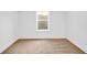 Bedroom featuring a cozy carpet, window and a modern neutral design at 1555 N Dearborn St, Indianapolis, IN 46201