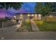 Inviting exterior view of a charming home with a landscaped front yard and a staircase leading to the entrance at 1555 N Dearborn St, Indianapolis, IN 46201