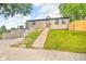 Charming home with a landscaped front yard and a staircase leading to the entrance at 1555 N Dearborn St, Indianapolis, IN 46201